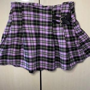 Purple skirt with black, white, and green stripes